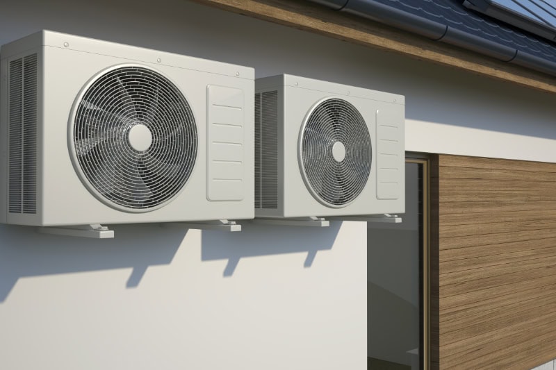 air conditioners attached to side of building.
