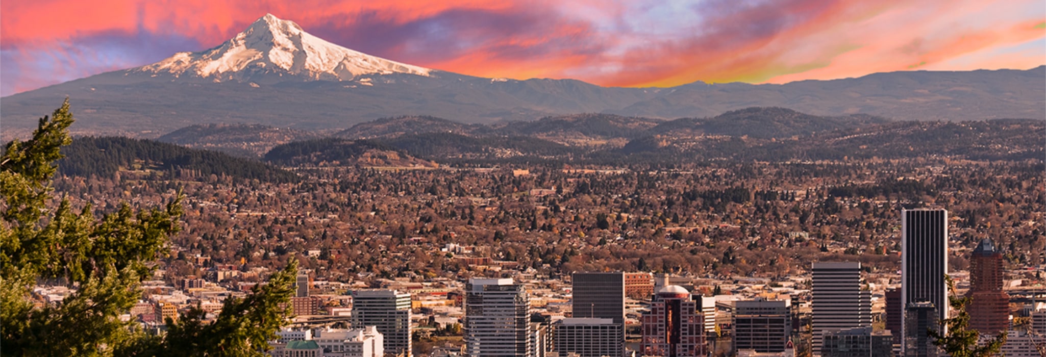 Portland skyline with an orange and pink sunset.